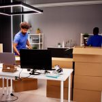 Professional,Movers,Packing,Boxes,In,Modern,Office